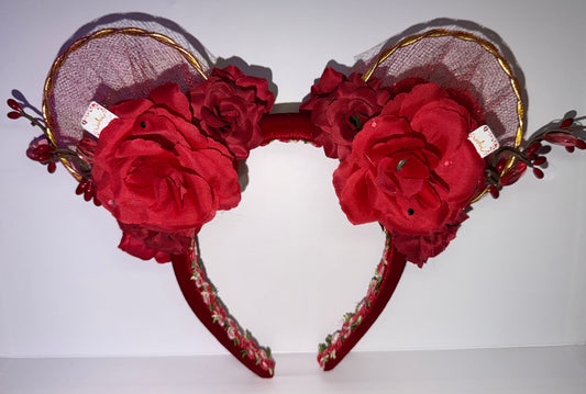 Red floral mouse ear headband with gold accents on a white background
