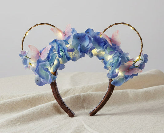 Floral headband with LED lights on a plain background